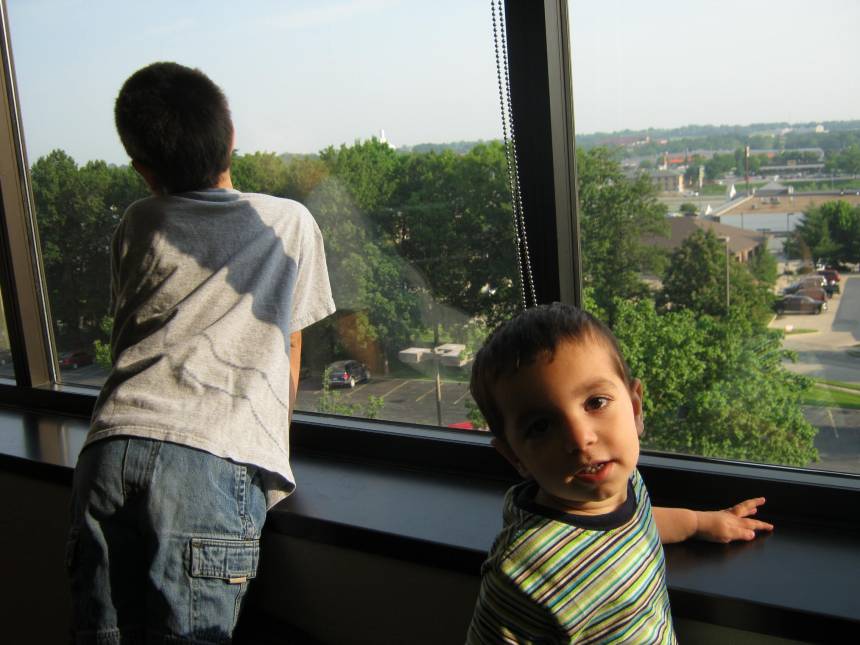 Boys looking out window at ultrasound clinic