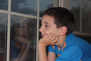 I love this picture, because the reflection in the window is Baby Alex staring back at his 9-year-old counterpart.